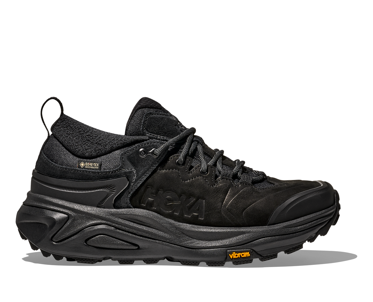 Black hiking shoe with visible brand logos on a white background