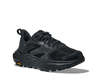 Black athletic shoe with orange Vibram logo on sole on a white background