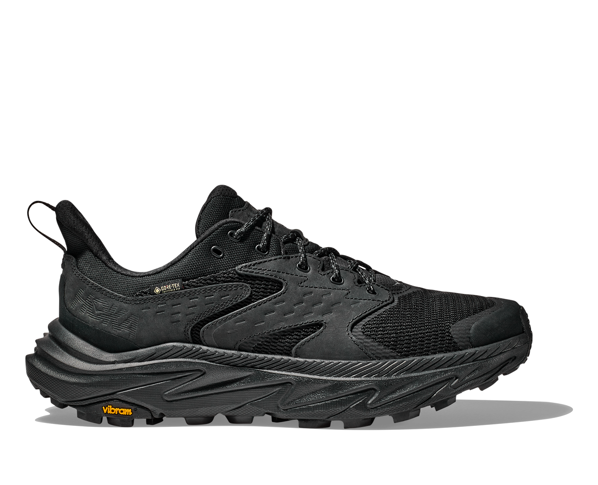 Black hiking shoe with orange Vibram logo on a white background