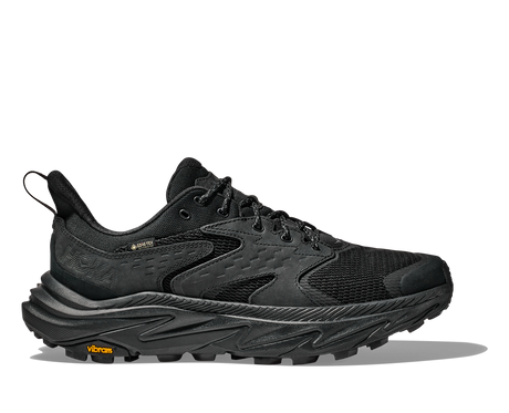 Black hiking shoe with orange Vibram logo on a white background