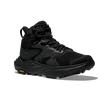 Black hiking boot with orange Vibram logo on sole on a white background