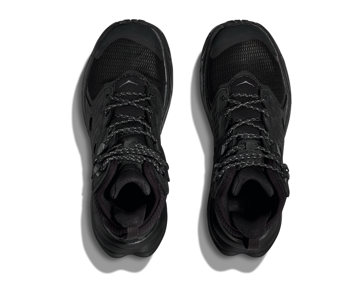 Pair of black high-top sneakers on a white background