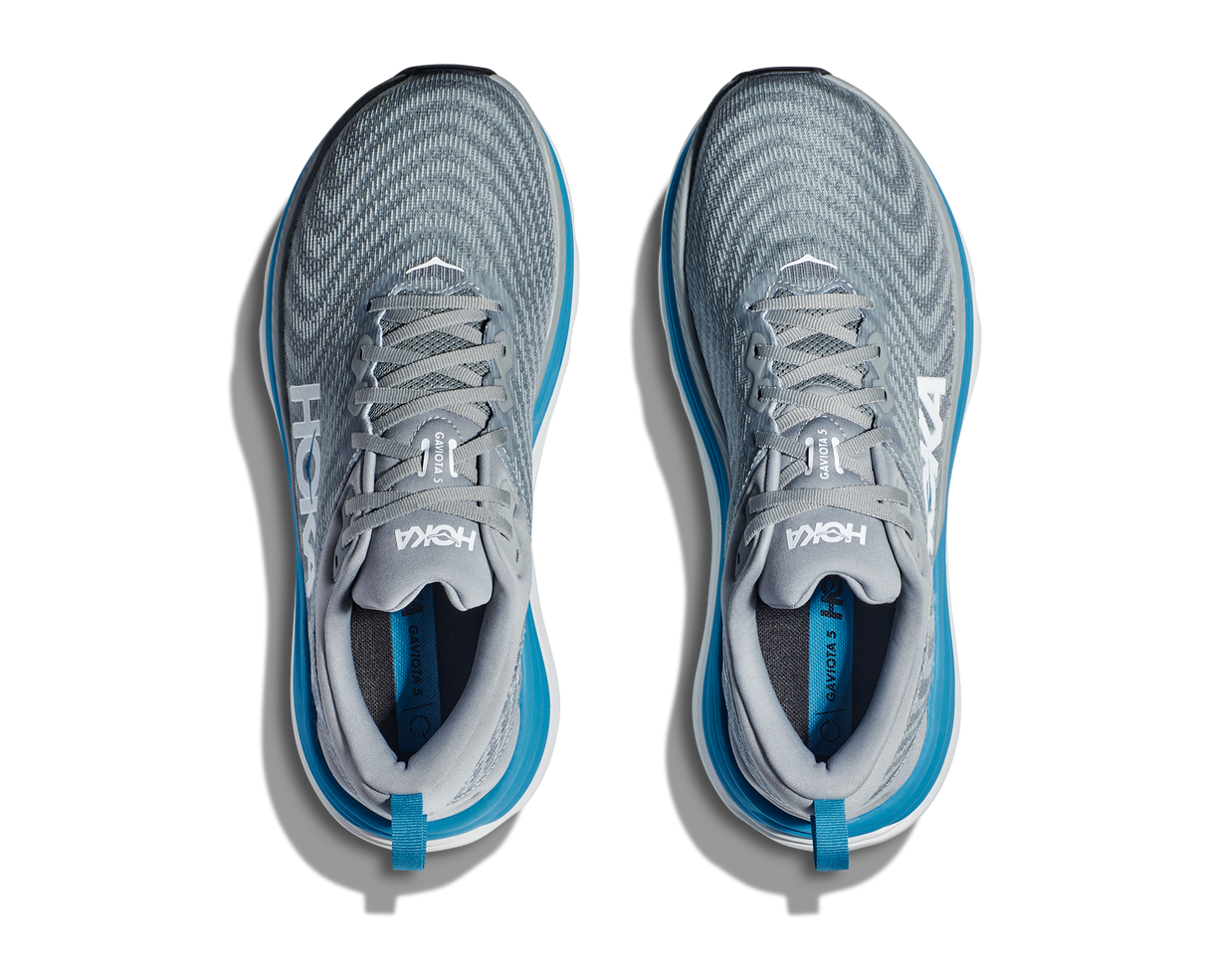Gray and blue running shoes on a white background