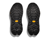 Black shoe soles with yellow accents on a white background