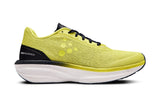 Yellow running shoe with black accent and white sole on a white background