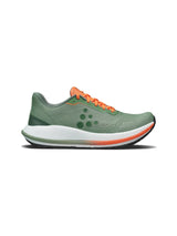 Green running shoe with orange accents on a white background
