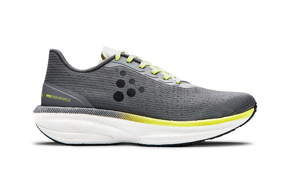 Grey running shoe with yellow accent and white sole on a white background