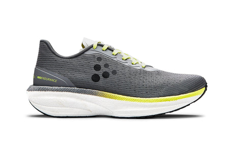 Grey running shoe with yellow accent and white sole on a white background