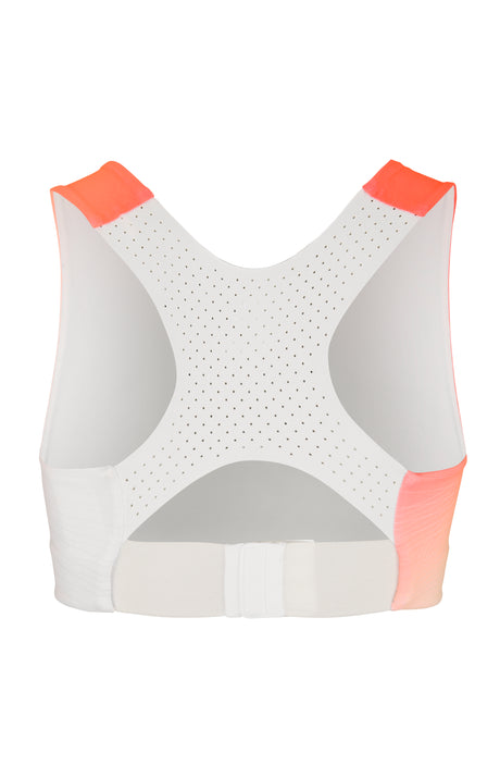 A women's sports top with a gradient of orange to white color, featuring the brand logo 'CRAFT' on the chest area.