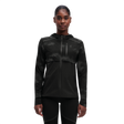 A woman wearing a black weather jacket with reflective elements on the sleeves and chest.