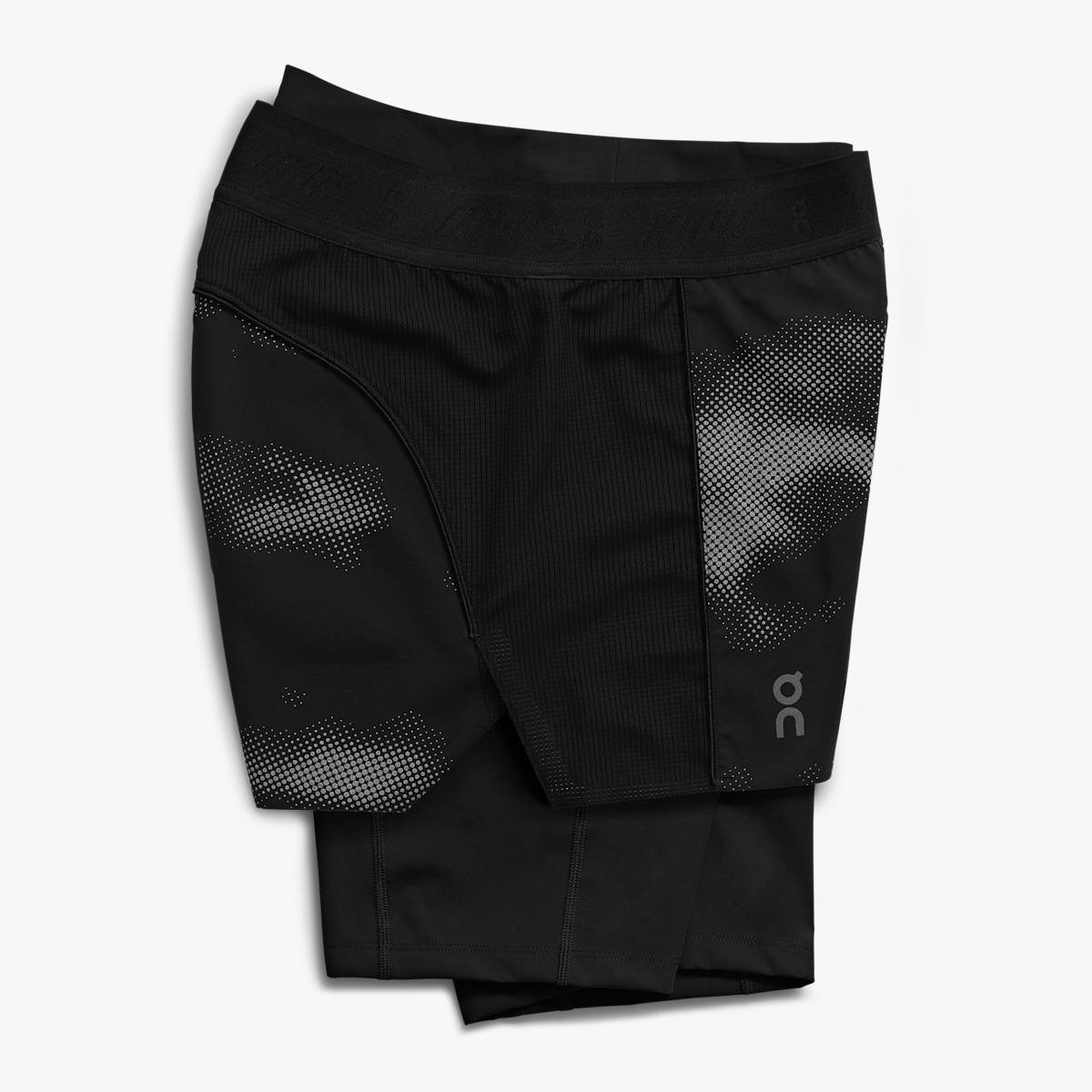 A pair of black women's active shorts with a subtle pattern and reflective details.